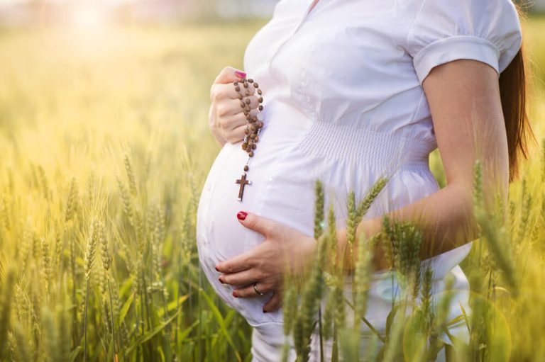 Pregnant mother with rosary